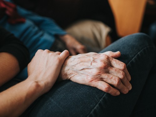 ounger person holder an older persons hand, used in a post about Aidaly