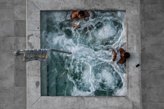 A bubbling hot tub with two people in it