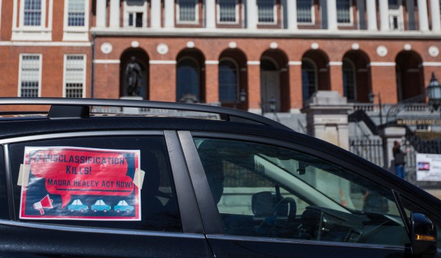 Uber and Lyft drivers participate in a "rolling rally" around the Boston Common on April 6 to protest the classification of ride share drivers as independent contractors, which limits their ability to apply for unemployment despite the coronavirus keeping most of their customers indoors.