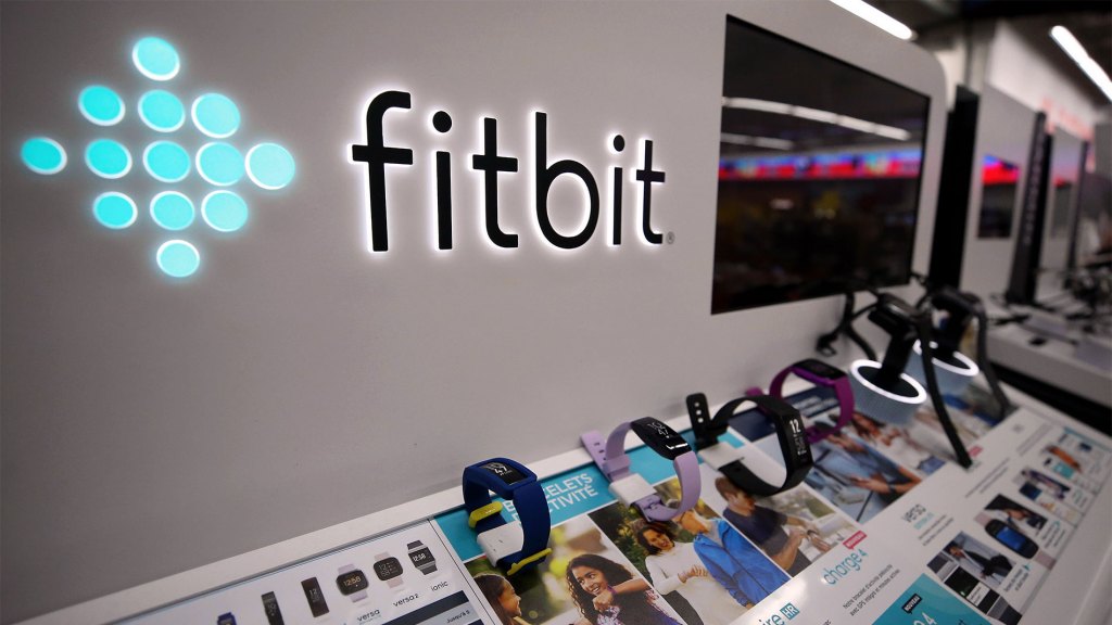 Fitbit logo with row of Fitbits on display