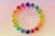 Digital generated image of many lollipop organised into circular pattern on pink surface.