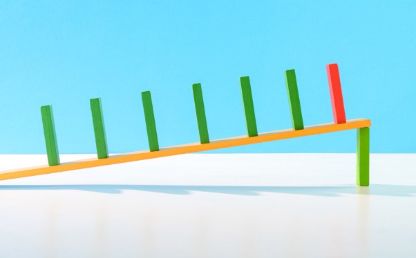 Dominoes on an inclined plank held up by a single domino -- relationship between stock market and startup valuations