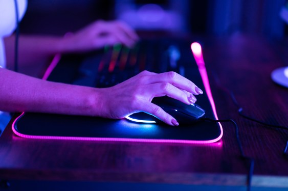 Close-up of woman's hands playing a computer game, used in a story about MMORPG-lite Tatsumeeko