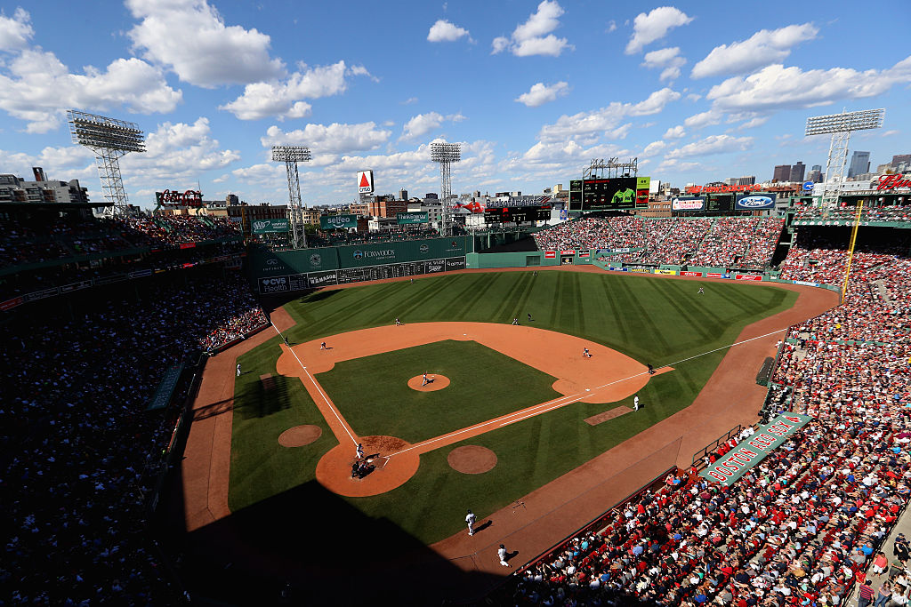 Fenway Park full of fans with green monster and Citgo sign visible in the distance.