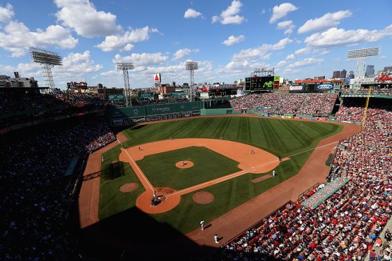 Fenway Park full of fans with green monster and Citgo sign visible in the distance.