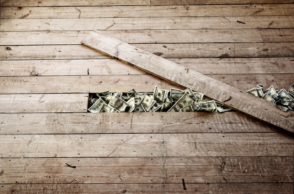 100 dollar bills stashed under a floorboards