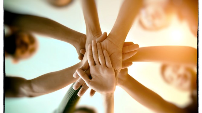 Team Teamwork Join Hands Partnership Concept, used in a post about Thai earned wage access startup Salary Hero
