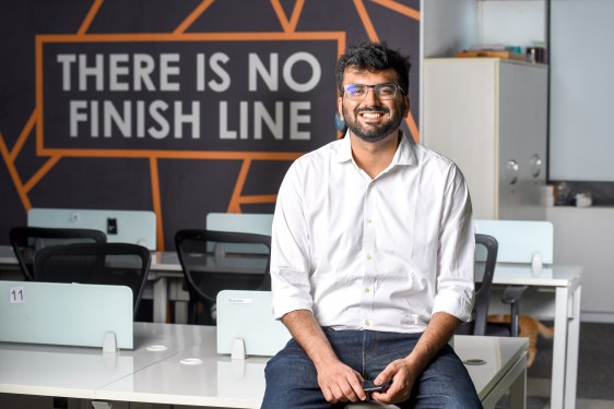 man sitting on desk at Slice office
