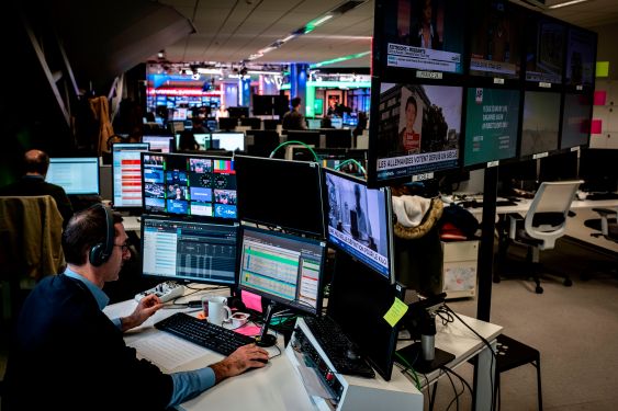 A newsroom in Europe with computer screens