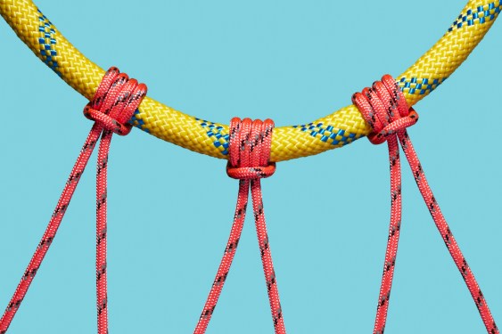 Three coloured ropes supported by a larger rope; investors support founders downturn