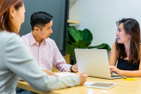 Group of workers strategize in a co-working space, used in a post about Southeast Asian HR automation software Omni