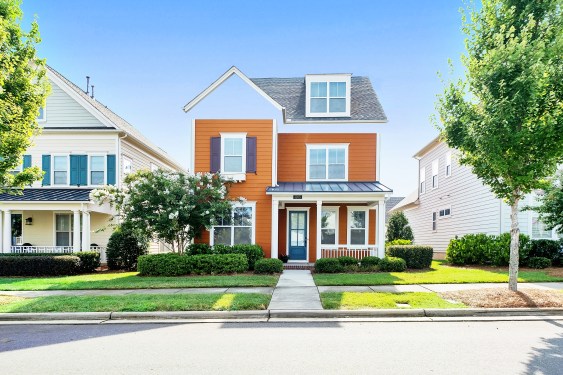 A red house with a green lawn