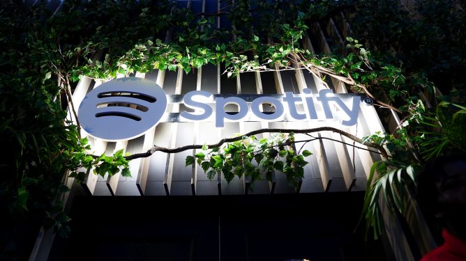 large Spotify logo surrounded by foliage