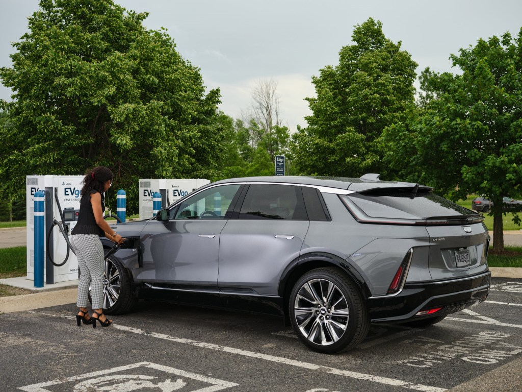 Woman charging an electric vehicle