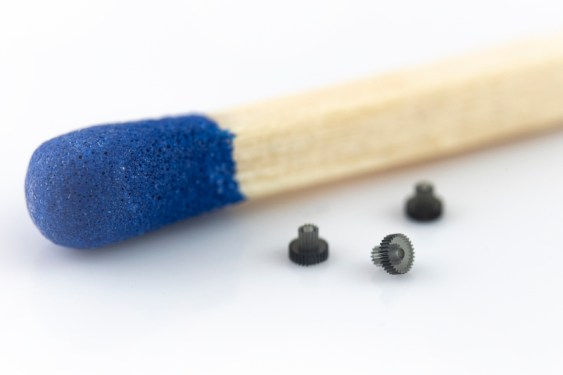 Tiny gears next to a match head