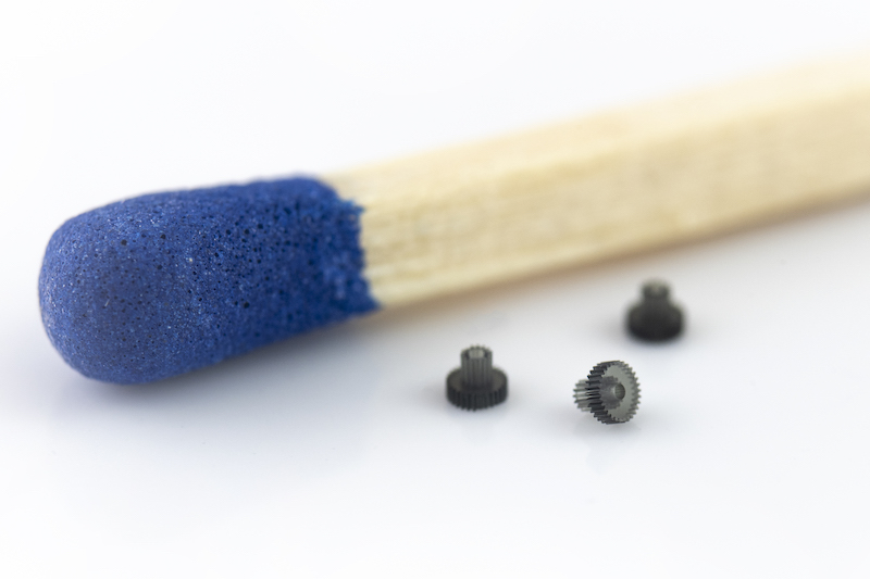 Tiny gears next to a match head