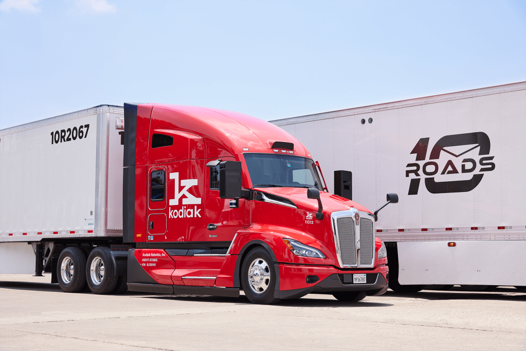 Red heavy duty truck with Kodiak Robotics logo in front of freight with 10 Roads logo