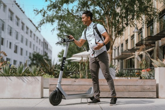 man about to ride a Bird e-scooter