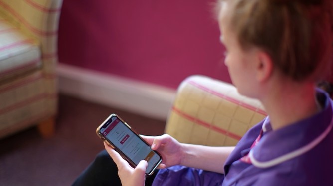 person sitting, using smartphone
