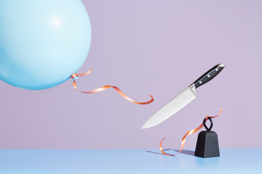 A kitchen knife releasing a tied-up balloon