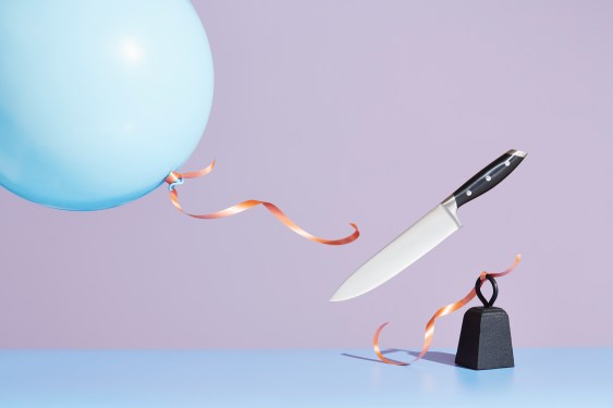 A kitchen knife releasing a tied-up balloon