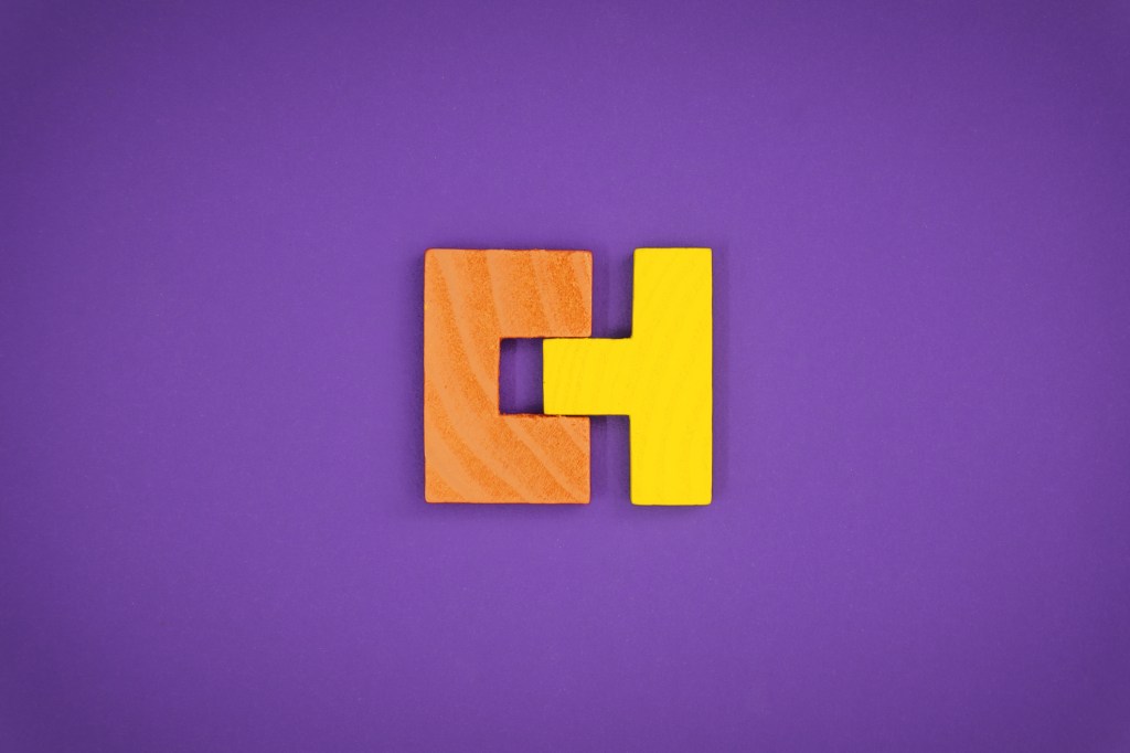 Perfectly Fit Together Concept With Wood Block Puzzle; getting acquired startup building