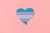 Paperboard heart with the transgender flag on a pink background