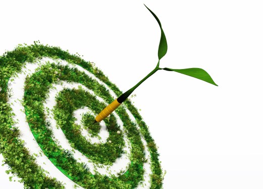 Image of a green dart hitting a green dartboard covered in grass.