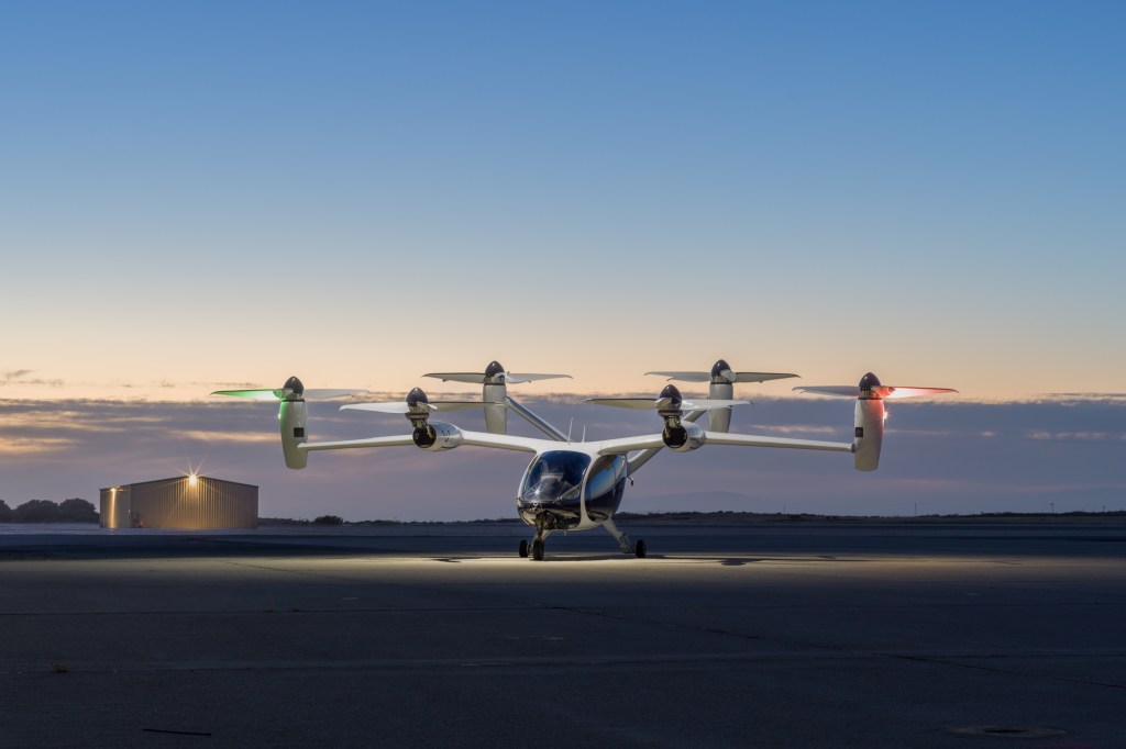 electric vertical takeoff and landing vehicle at a marina at sunset