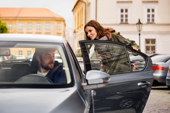 woman getting into car