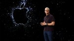 Tim Cook standing next to a sparkly Apple logo