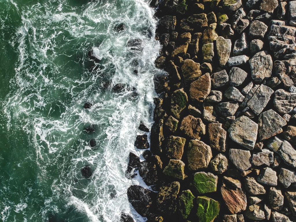 Image of waves hitting a rocky beach.