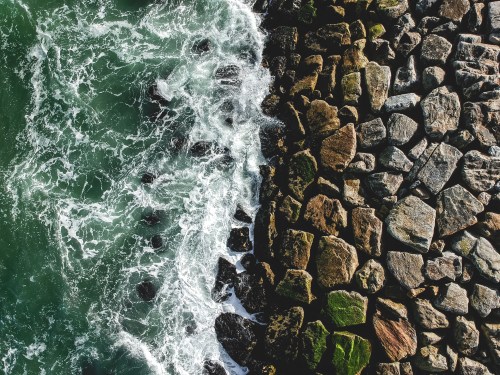 Image of waves hitting a rocky beach.
