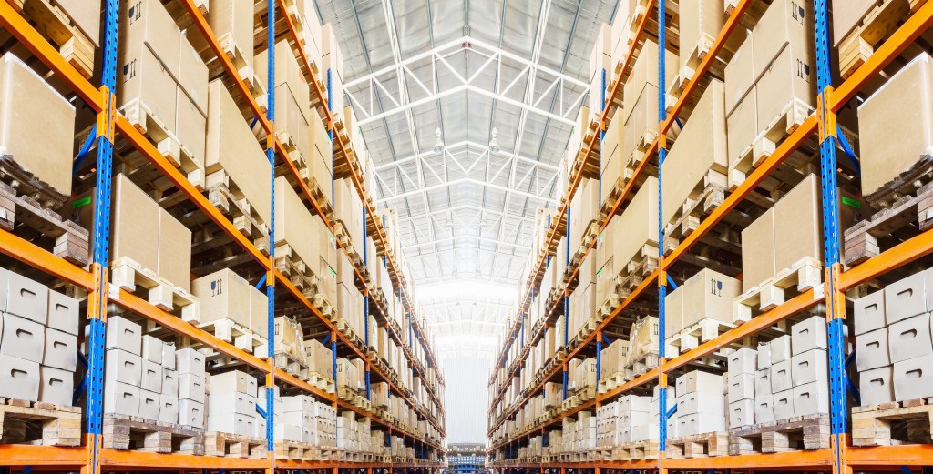 Rows of shelves with boxes in modern warehouse