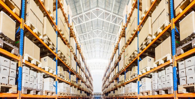 Rows of shelves with boxes in modern warehouse