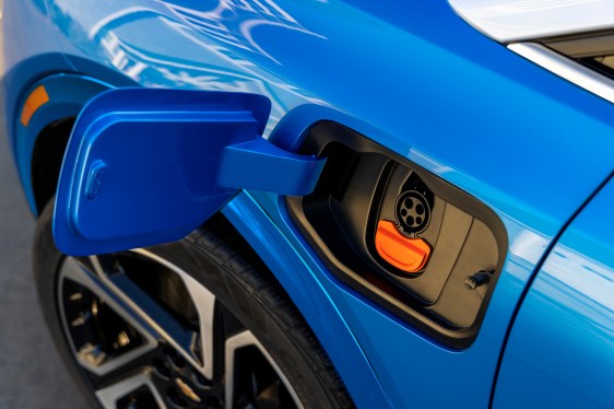 A closeup of the charging port on a Blue Chevrolet Equinox
