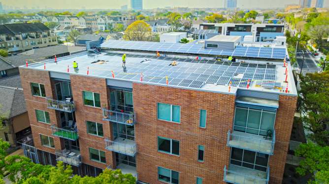 PearlX installs solar panels on a multifamily apartment building.