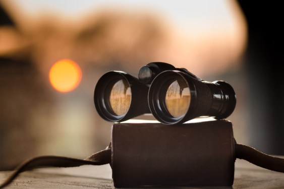 binoculars atop case with strap