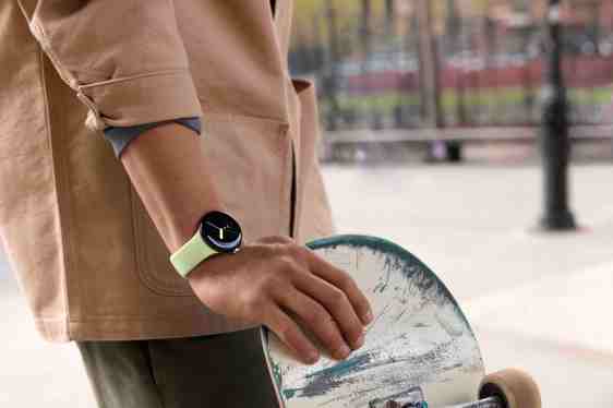 person wearing Google Pixel Watch, holding a skateboard