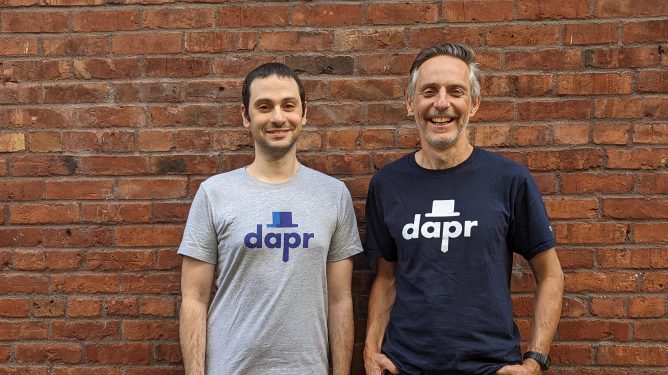 Diagrid founders standing in front of brick wall