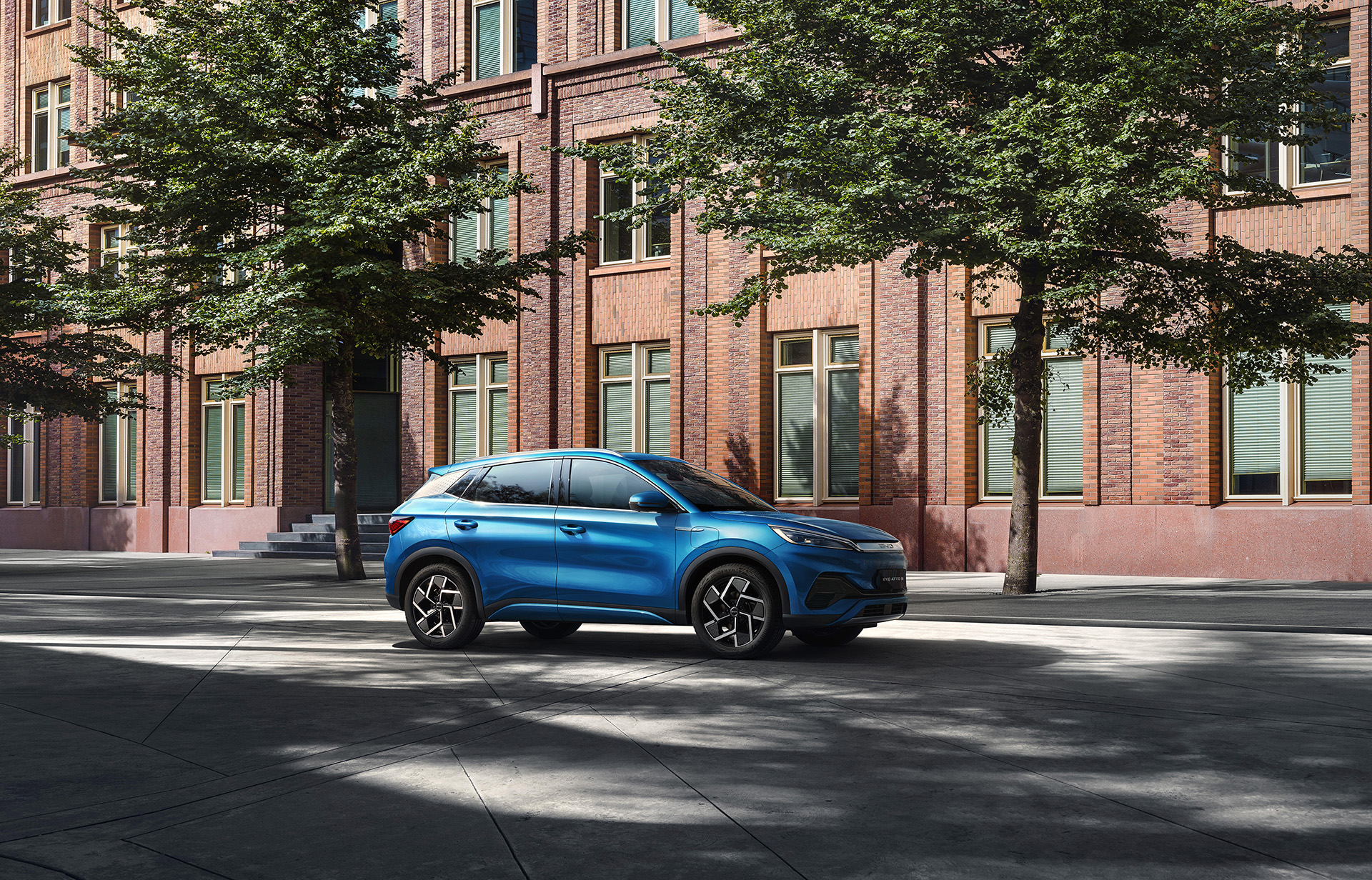 blue BYD Atto 3 electric vehicle SUV on city street