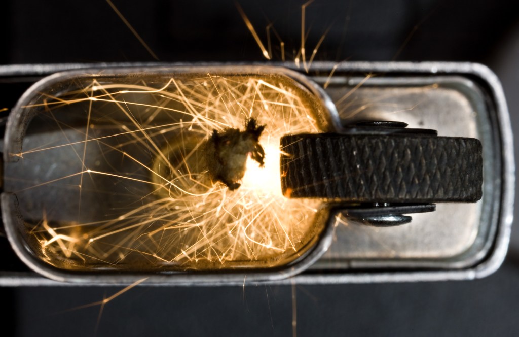 A Zippo lighter sparking up, seen from above.