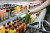 Image of a person reaching for a beverage in a supermarket.