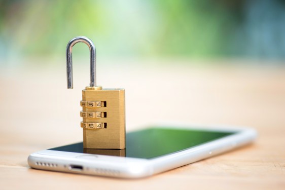 Smartphone with an open lock on top of it, used in a post about open finance startup Ayoconnect