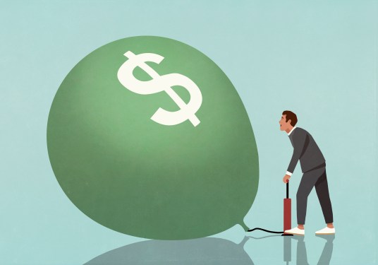 man pumping up balloon with dollar sign on it