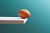 An egg teetering on the edge of a plank