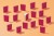A group of books laid in a pattern on a colorful background. one is standing out from the crowd