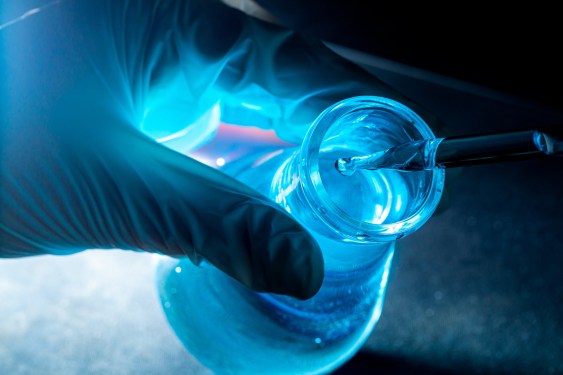 Blue science experiment glass tube, Researchers with chemistry test tubes in a liquid glass lab for analytical, medical, pharmaceutical and scientific research concepts