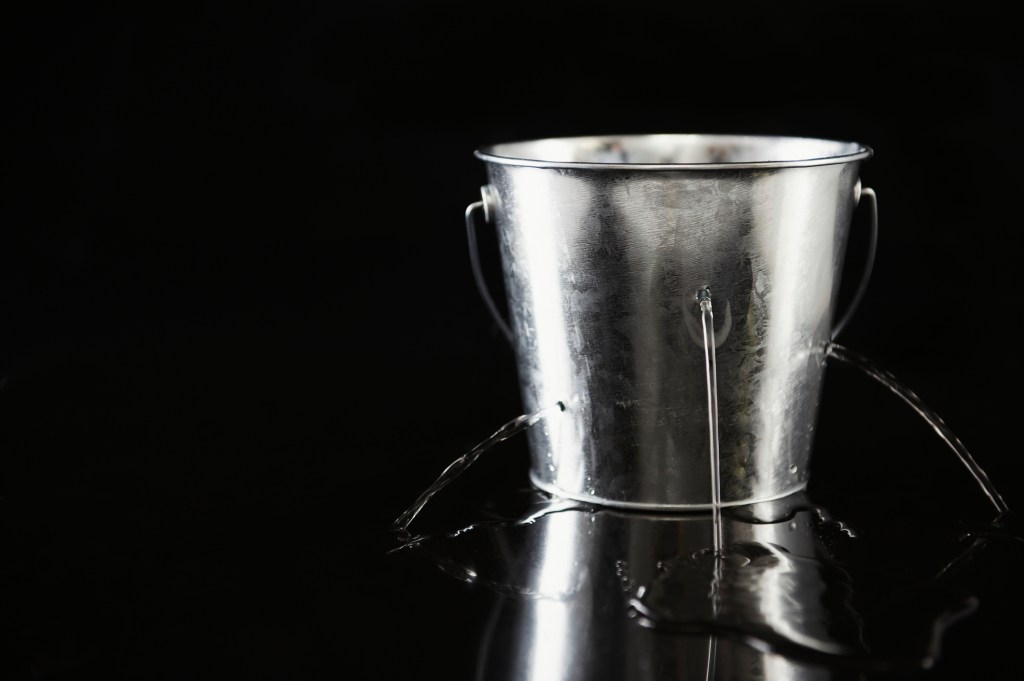 Water pouring out of holes in bucket
