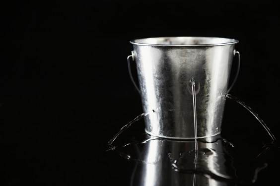 Water pouring out of holes in bucket